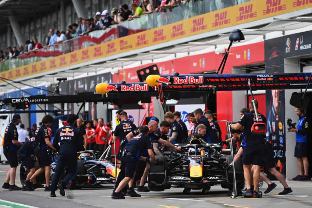 Red Bull Racing crew preparing the car in the pit lane during a Formula 1 weekend.
