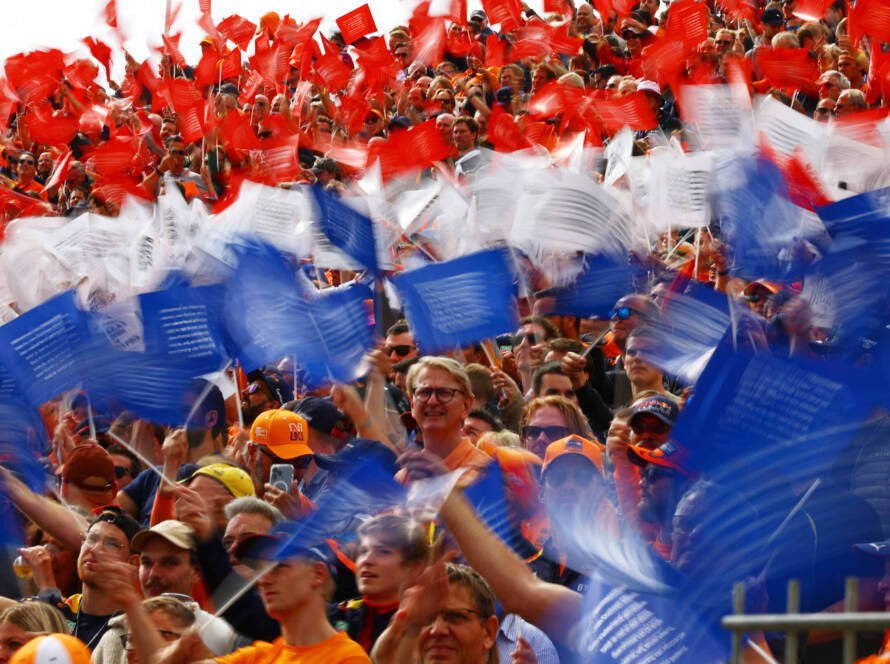 Dutch fans in orange wave flags in the grandstands during the Zandvoort weekend